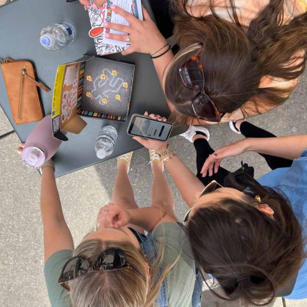 Friends playing escape room box game