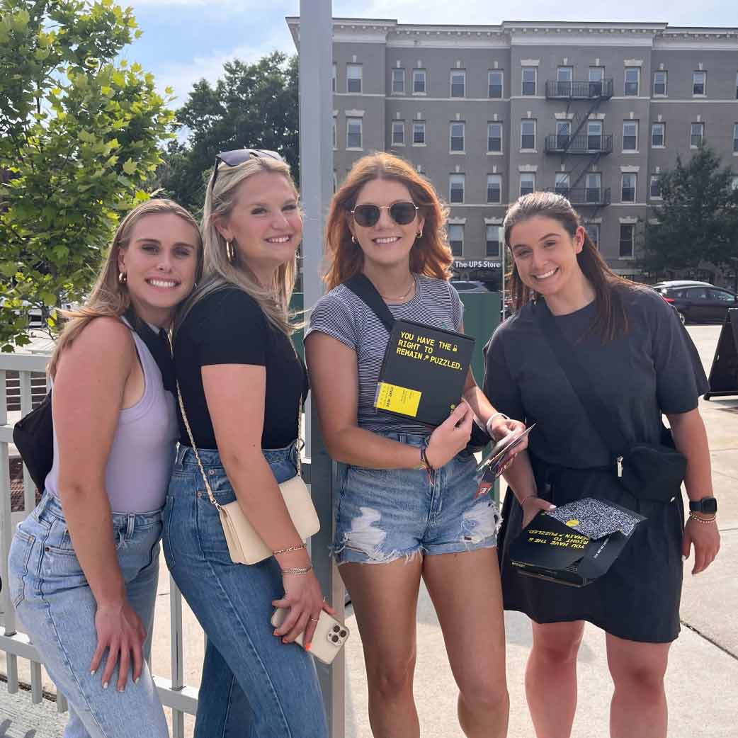 Players holding the escape room box